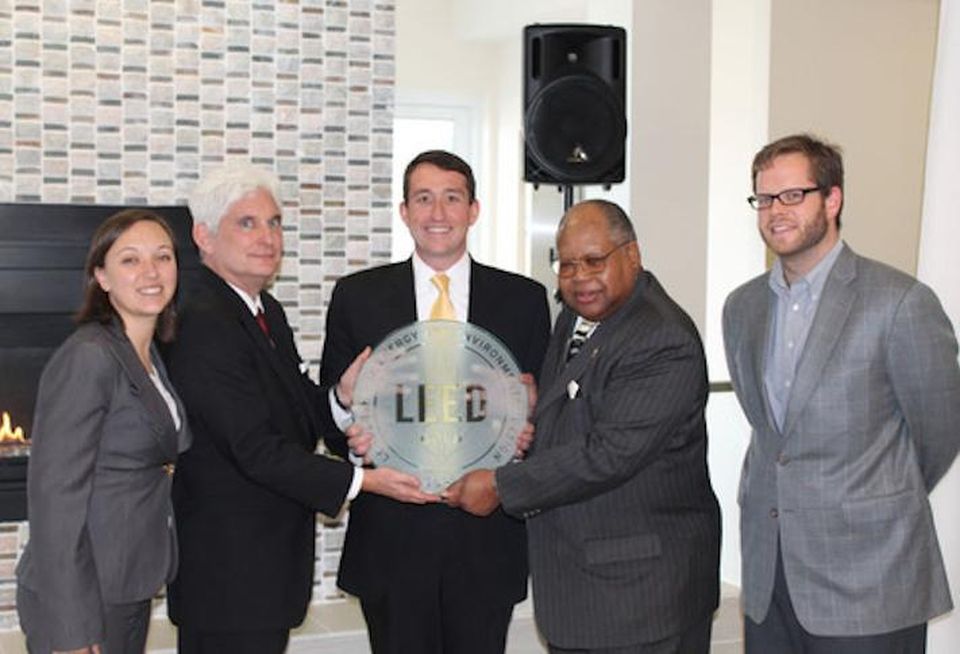 Fore Property Co.'s Jim Sullivan (center) accepting a LEED certification plaque