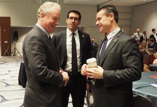 Sen. Chris Van Hollen, HUD Deputy Chief of Staff Alfonso Costa and Sen. Todd Young speaking before a Bisnow panel