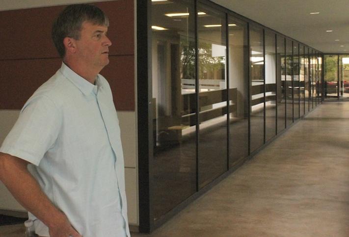 The Ardent Cos. Managing Director Mike Guynn looking out over the courtyard from Piedmont Center I in Buckhead in Atlanta.
