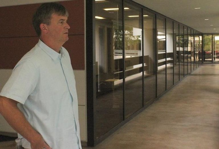The Ardent Cos. Managing Director Mike Guynn looking out over the courtyard from Piedmont Center I in Buckhead in Atlanta.