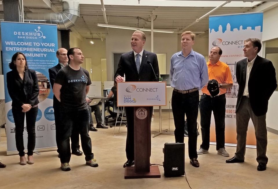 Mayor Faulconer (center) announcing highlights of the 2016 CONNECT Innovation Report surrounded by local entrepreneurs. Left to right are Abreos Biosciences chief scientists Dr. Dina Uzri, Benefunder managing director Tom Paparatto, DeskHub president/CEO Jay Chernikoff, Mayor Faulconer. CONNECT president/CEO Greg McKee, Chalk Digital founder/CEO Craig Hagopian, and Portable Genomics CEO Patrick Merel.