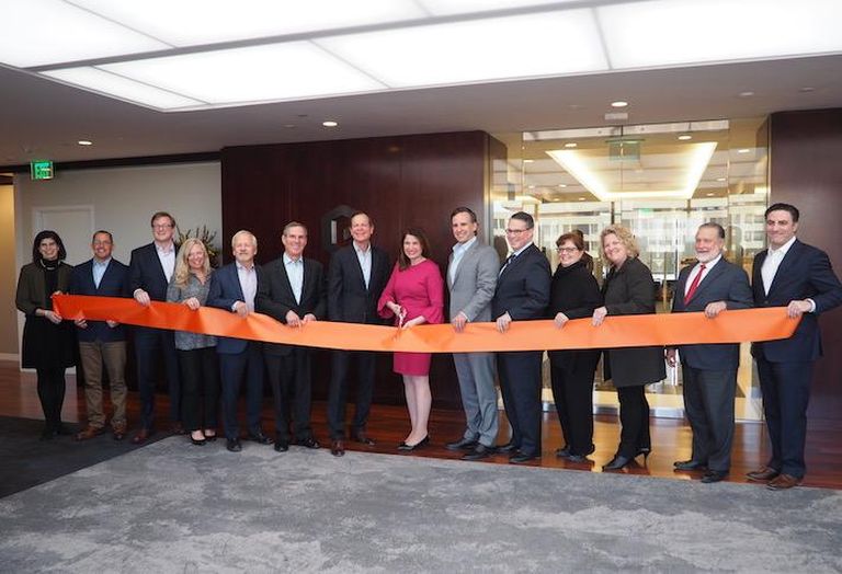 Goodwin cutting the ribbon in the 10th story lobby of its its new office