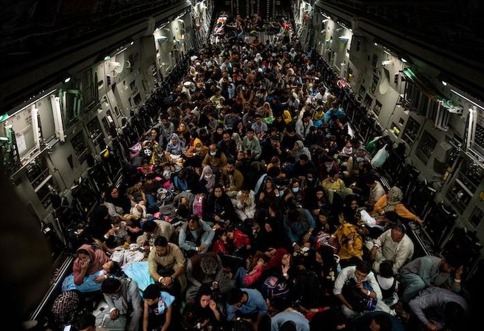 Afghan refugees evacuating the country on a U.S. aircraft in August 2021.
