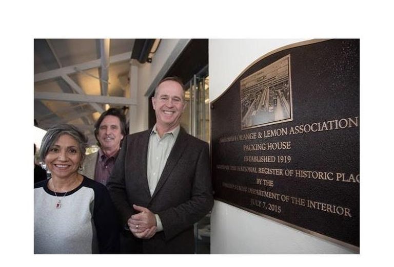 (L-R) Anaheim Community Investment Manager Laura Alcala, Community and Economic Development Director John Woodhead, and Mayor Tom Tait pose with The Packing House Placard.