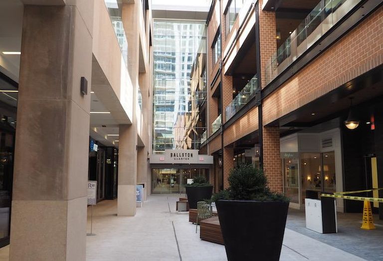 A side entrance to Ballston Quarter with open-air retail storefronts in a space previously occupied by Macy's Furniture Store