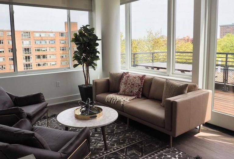 The upstairs lounge and balcony in one of the two-level penthouse units at the Madison House development