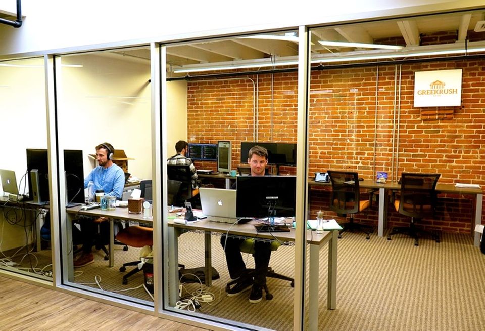 Team members are seated in close proximity at DeskHub,San Diego.