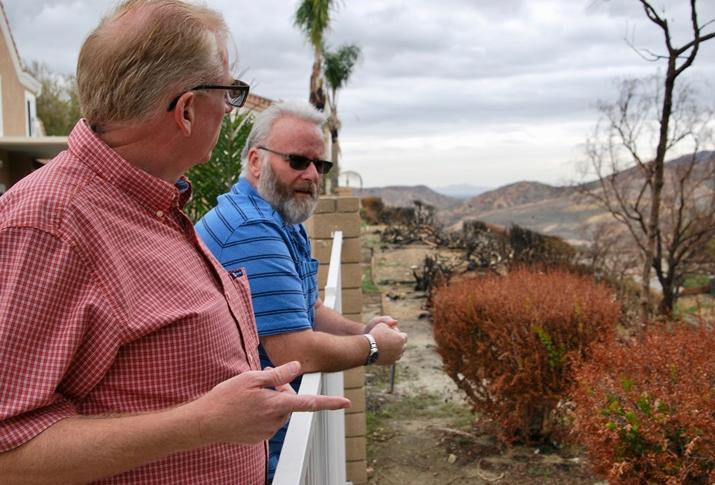 Residents Brian Stanley and Willie Laundrie look at the charred vegetation that caught fire from the Canyon Fire 2 wildfire behind Laundrie's home in Anaheim Hills. Brian Stanley and Willie Laundrie look at the charred vegetation that caught fire from the Canyon Fire 2 wildfire behind Laundrie's home in Anaheim Hills.