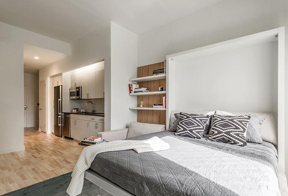 Apartments are outfitted with space-saving furnishings such as a queen-size Murphy bed, versatile desks and a coffee table that expands into a dining table that seats eight.Units also come with a two-burner induction cooktop, a combination microwave and convection oven and walk-in closet. About half of the furnished apartments boast a shelf that protrudes from the upright bed and remains horizontal when the bed is lowered from the wall. Finally, a long sideboard is included with an LED television on top.