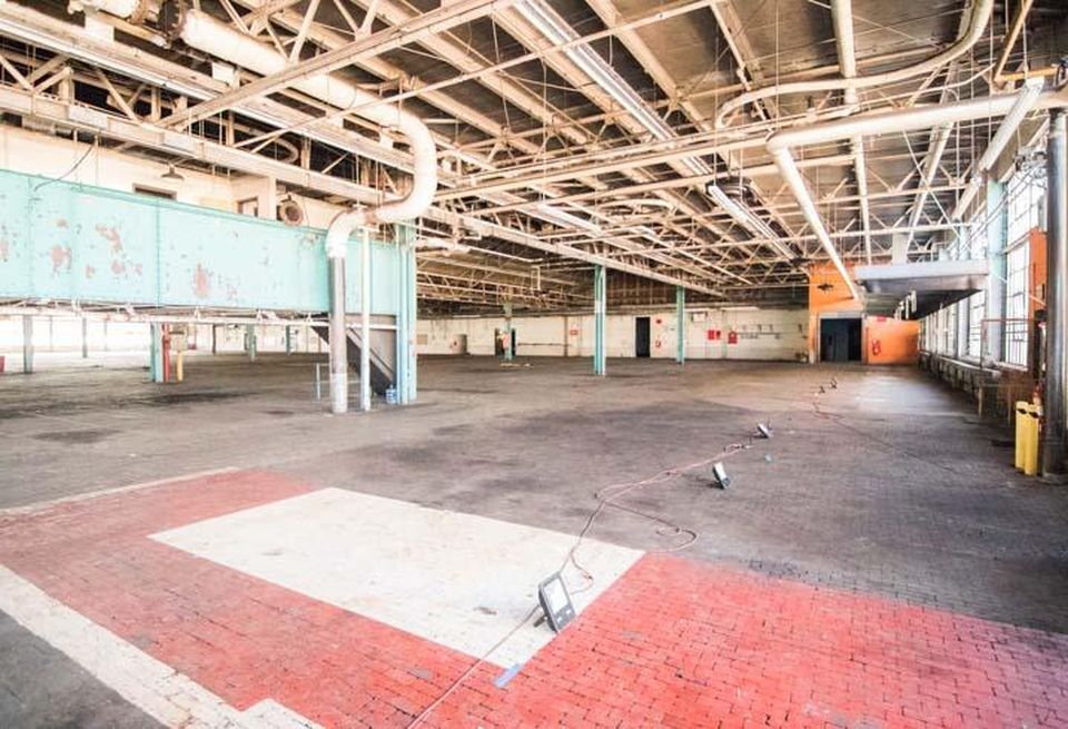 Green bathroom pods can be seen in the former assembly plant at Camp North End