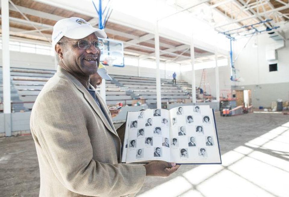 Arthur Griffin grew up a few blocks from Brooklyn Charlotte. After being forced out of downtown due to urban renewal, he would grow up to become the School Board chair and Head of the Black Political Caucus. Here, he shows off his yearbook at the Second Ward High School gym, which is being renovated into a community center and museum.