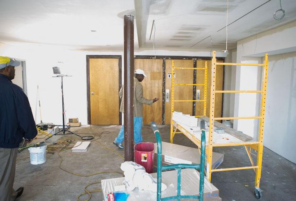 Mecklenburg County Park and Recreation Department planner James Williams, left, tours the former Second Ward High School gym with former Charlotte-Mecklenburg school board chair Arthur Griffin.