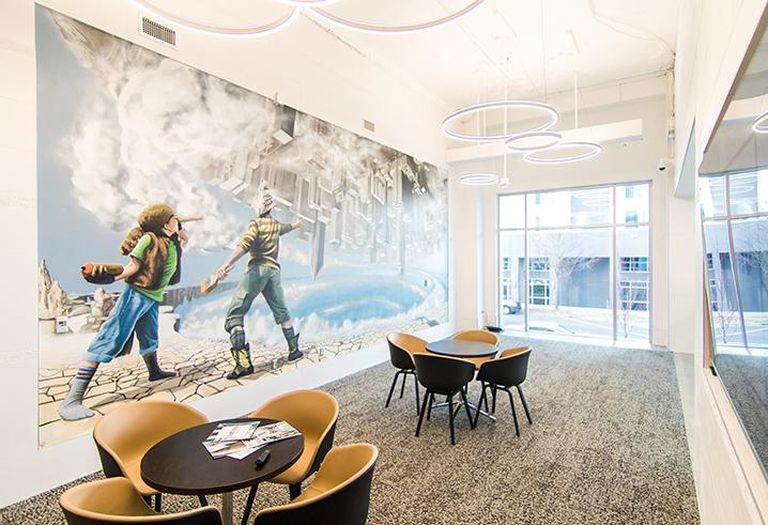 The lobby of 300 South Brevard includes a presentation area with a mural by Matt Hooker, Matt Moore and Tucker Sward.