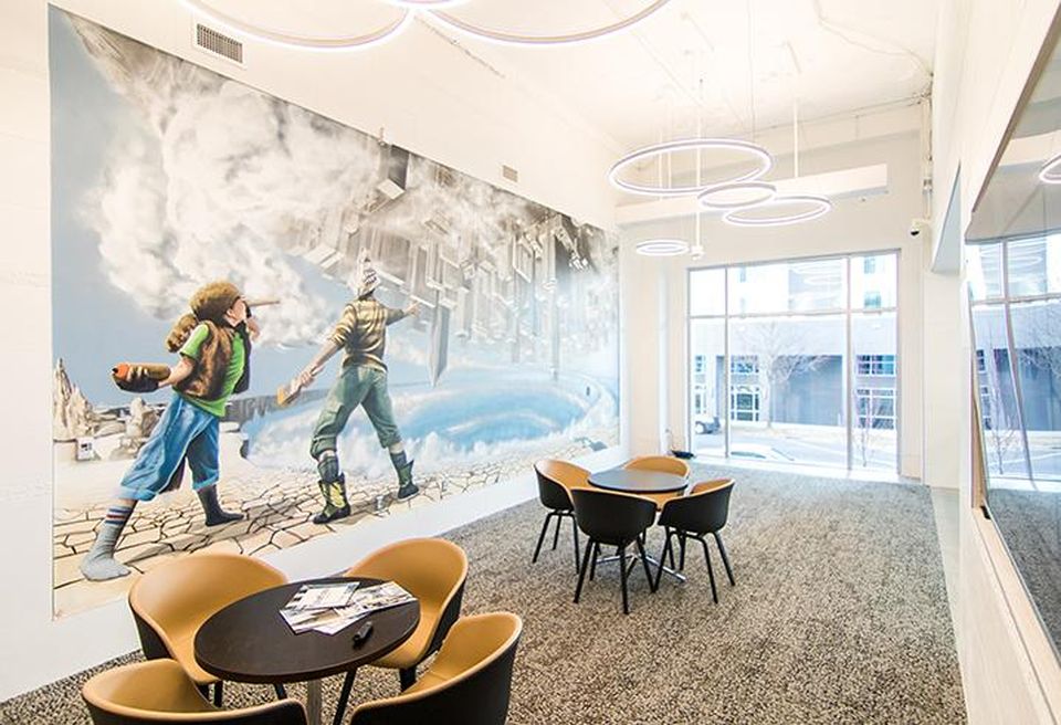 The lobby of 300 South Brevard includes a presentation area with a mural by Matt Hooker, Matt Moore and Tucker Sward.