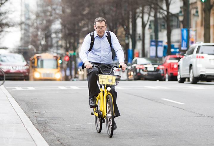 A bicycle commuter uses dockless bike ofo in Uptown Charlotte