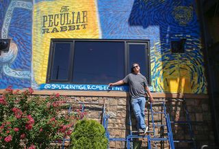 The Peculiar Rabbit owner Rob Nixon has a mural on the side of his restaurant created by Southern Tiger Collective. It serves as a way to work around the City of Charlotte's sign ordinance.