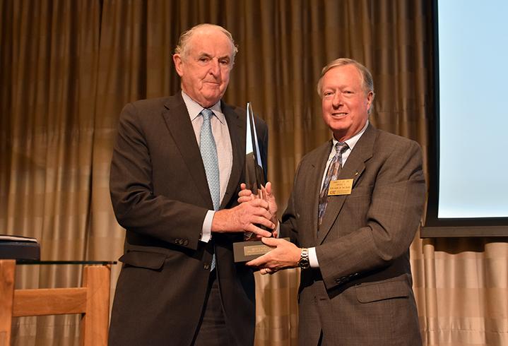 James Lee, right, presents the Counselors of Real Estate Landauer/White award to Colliers International, Boston Co-Chair Kevin Phelan in 2016