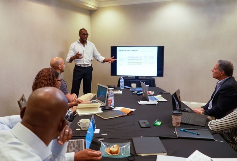 Tawan Davis (standing) at an Steinbridge Group executive meeting. 
