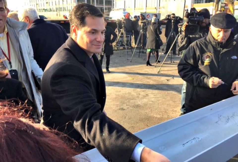 Clark Street Real Estate principal Peter Eisenberg signs the ceremonial beam at the Retail at the Fields groundbreaking in Chicago, Jan. 18, 2017.