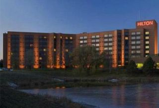The owners of the Hilton Lisle Napervillle are accused of owing $37M in a loan originated in 2006.