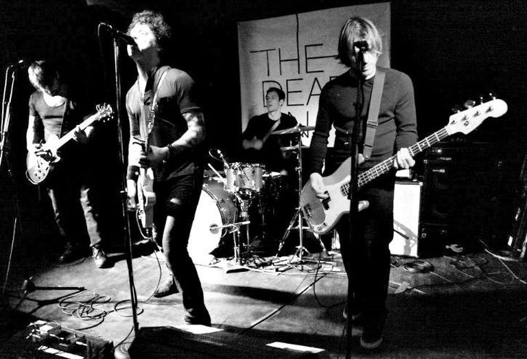 Cushman & Wakefield senior director Loren Guzik plays drum in local band The Dead On