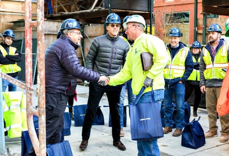 Related Midwest President Curt Bailey, center, and Senior Vice President of Construction Don Biernacki, left, joined other executives and employees from the company in distributing Thanksgiving turkeys to workers at the firm’s three construction sites, including One Bennett Park in Streeterville.