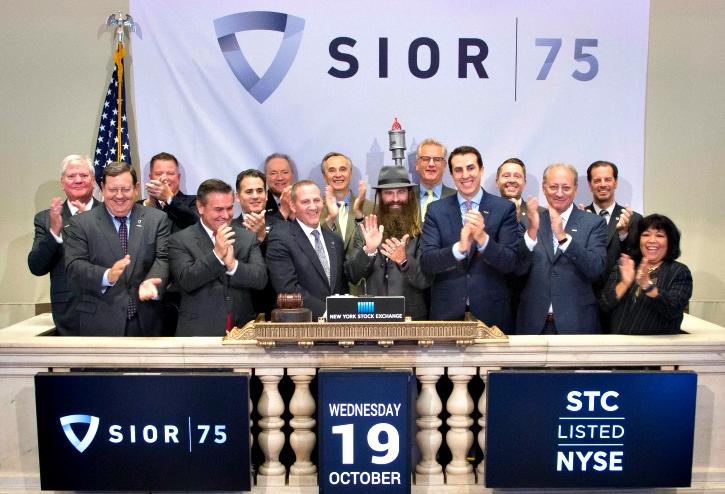 Members of the SIOR board of directors, including 2017 global president, NGKF executive managing director Geoff Kasselman (center, with gavel) ring in the New York Stock Exchange Oct. 10, 2016.