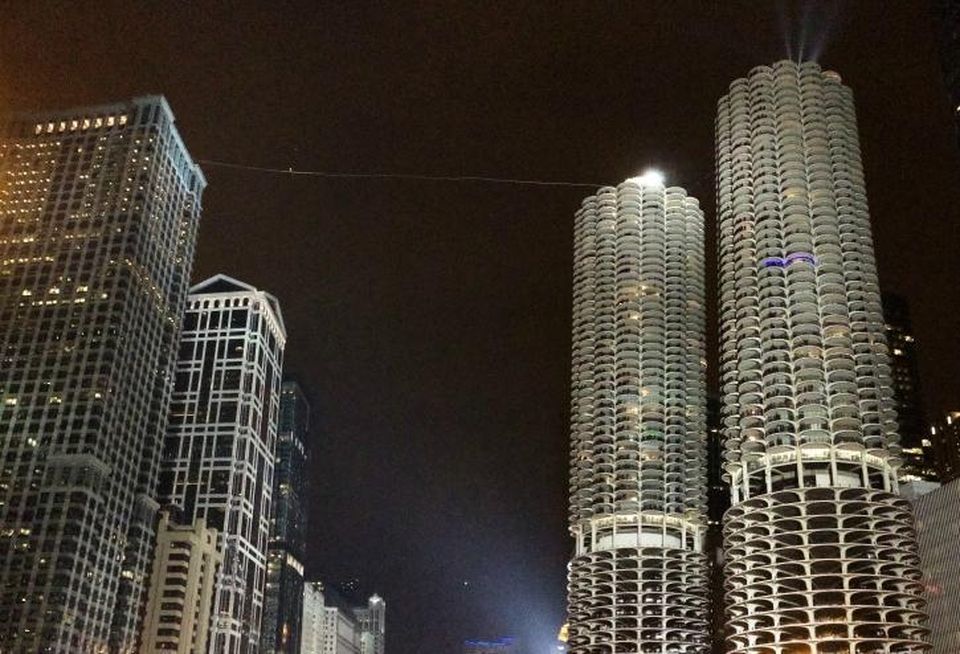 Aerialist Nik Wallenda walks a tightrope between Marina City and the Leo Burnett Building, Chicago, in November 2014.