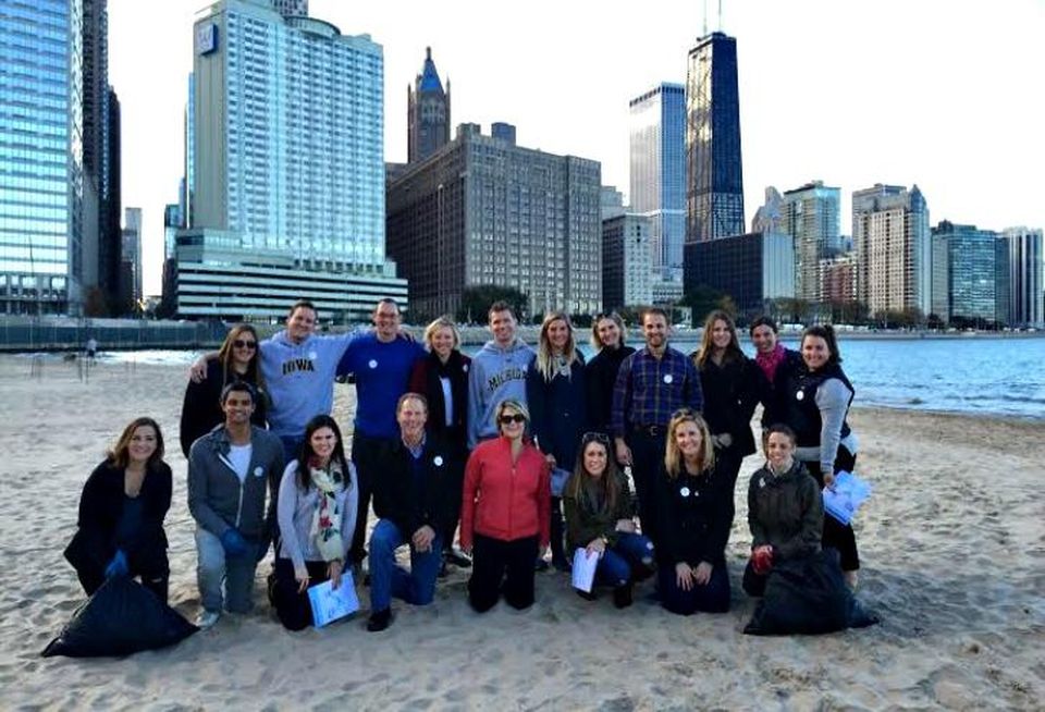 Members of JLL's Young Guns program cleaning up Oak Street Beach.