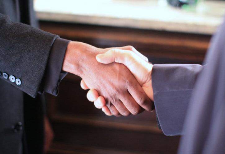 Shaking hands, making a deal, transaction, deal volume
