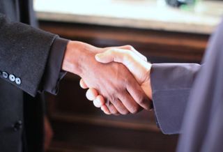 Shaking hands, making a deal, transaction, deal volume