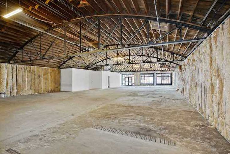 The sky-lit bow-truss roof has been soda blasted to restore its original appearance.