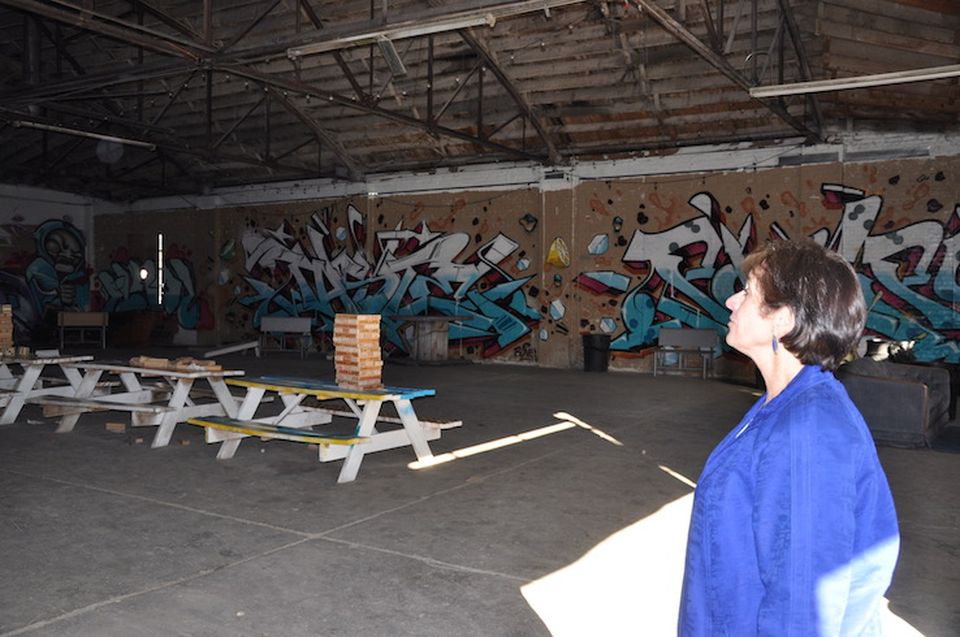 Susan Powers surveys the future restaurant space during Steam on the Platte's groundbreaking celebration last fall