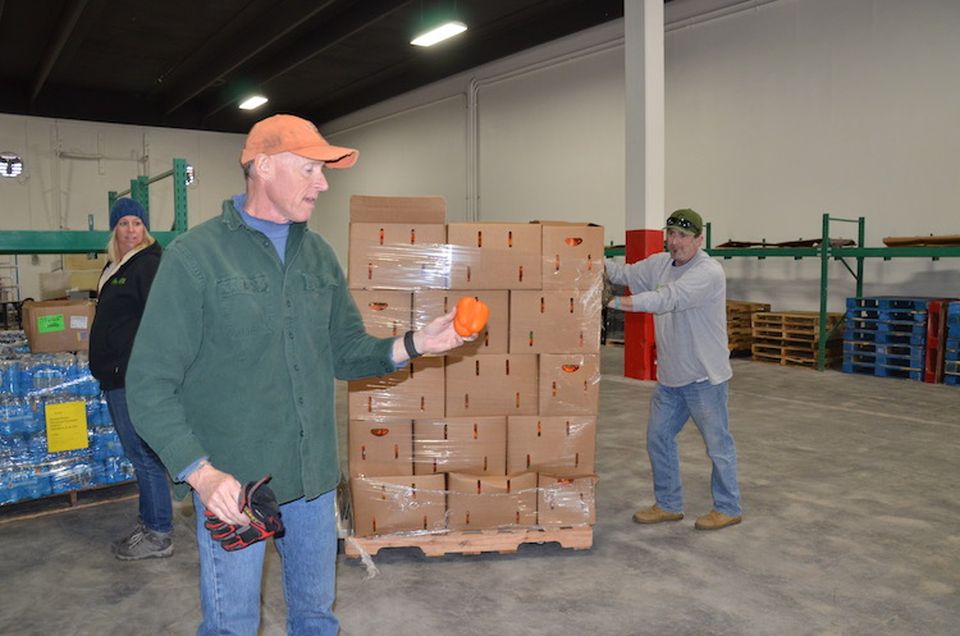 We Don't Waste Director of Operations Tim Sanford examines a bell pepper that was rejected by a grocery store.