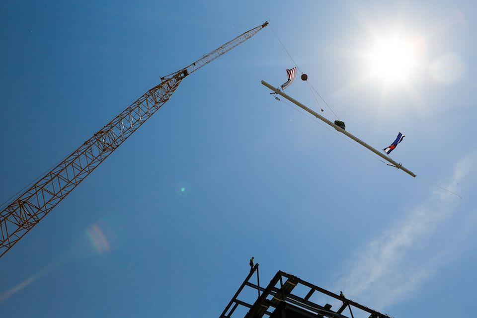 A beam is raised for the topping out of Catalyst