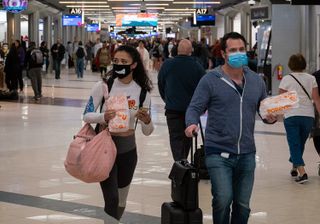 Flyers at Hartsfield-Jackson Atlanta International Airport wearing facemasks on March 6th, 2020 as the COVID-19 coronavirus spreads throughout the United States.