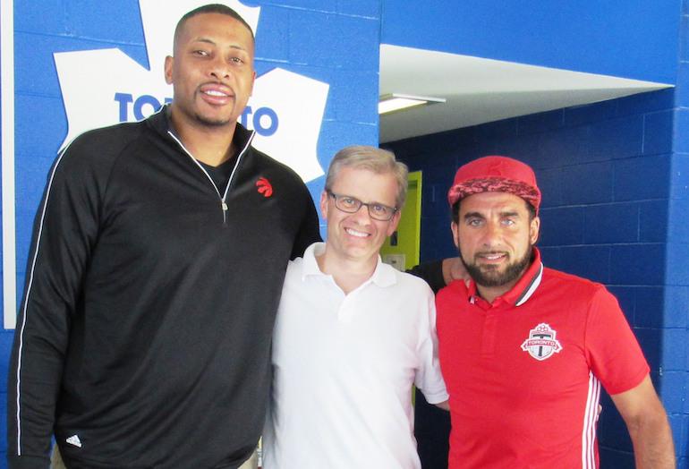 Daniels Corp VP Martin Blake (centre) with Toronto Raptors assistant coach Jamaal Magloire and Toronto FC’s Dwayne De Rosario