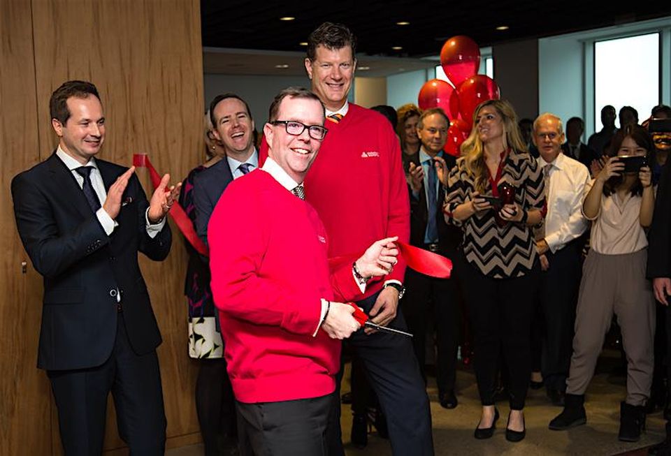 Cushman & Wakefield CEO Chuck Scott cuts the ribbon on his company's new office during grand opening celebrations.