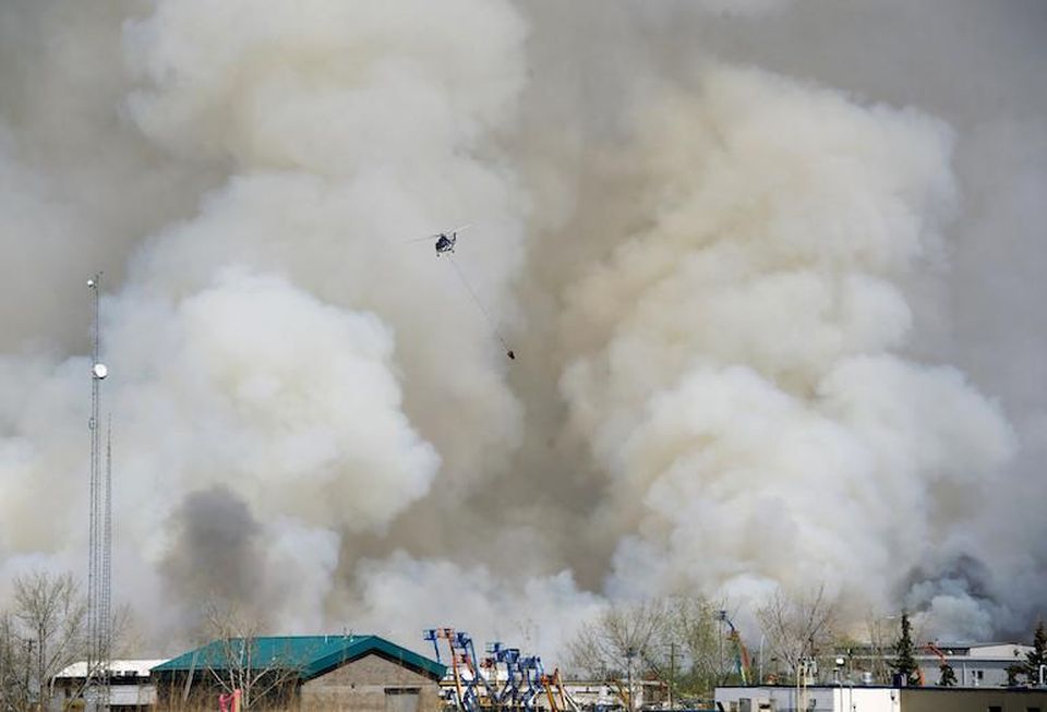 Crews battle the wildfire around Fort McMurray, AB