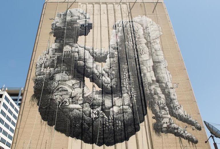 An eight-storey mural by street artist Phlegm, on the west-facing side of Slate-owned 1 St. Clair W.