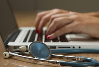Stethoscope and Laptop Computer