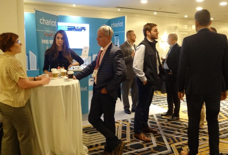 Attendees network near the Chariot booth at Bisnow's Office West event. Attendees network near the Chariot booth at Bisnow's Office West event