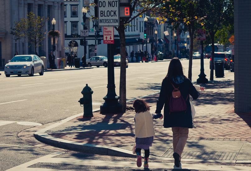 Mother walking child across the street