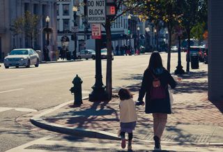 Mother walking child across the street