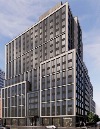 A modern high-rise building with a sleek glass facade on a city street, surrounded by other contemporary structures under a partly cloudy sky.