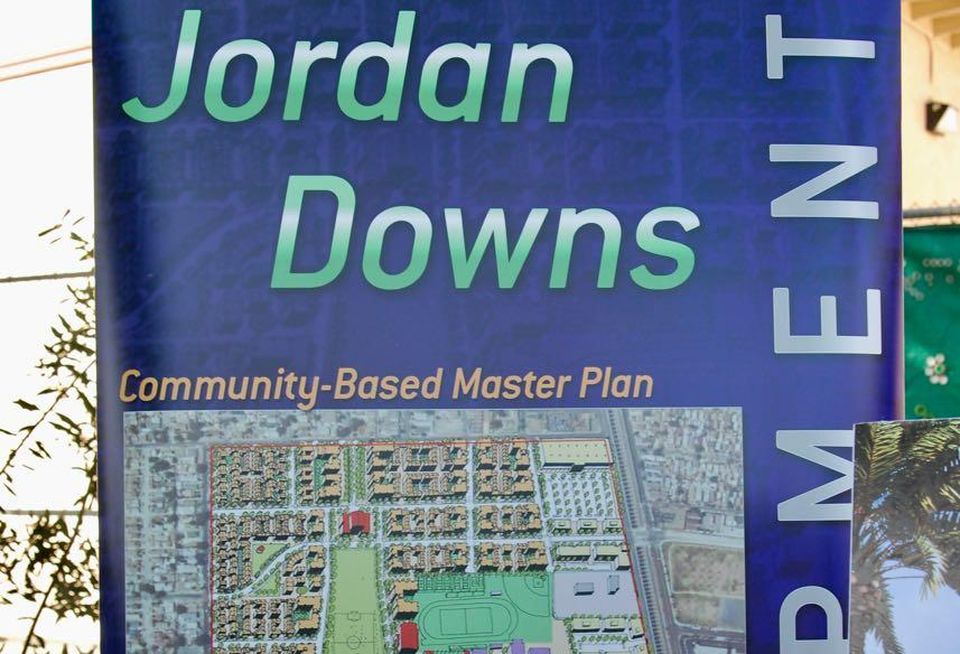 An advertisement banner of the Jordan Downs redevelopment project at Markham Middle School in Watts.