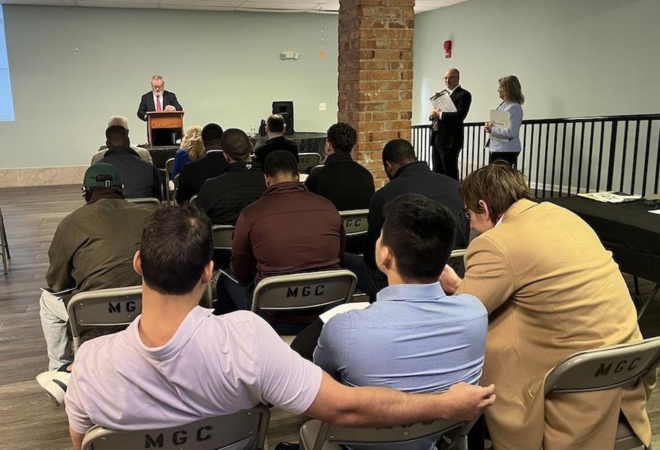 The auction drew a crowd, but it failed to garner a high enough bid to sell the Meadow Green Courts property.
