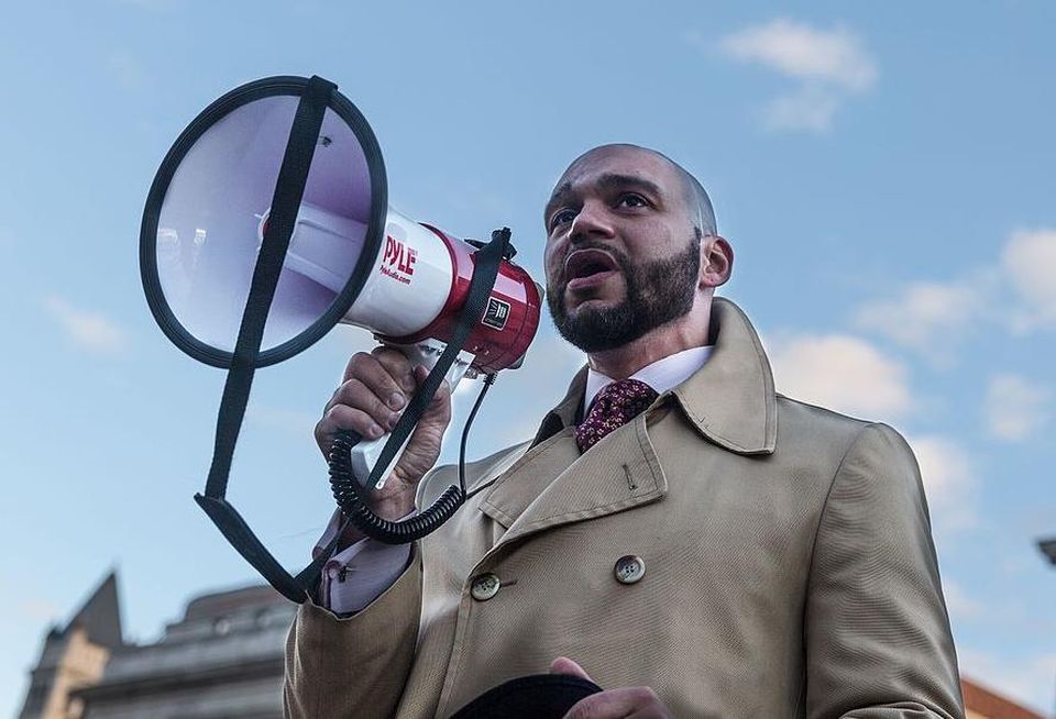 DC Councilmember Robert C. White speaking at a rally against Trump's