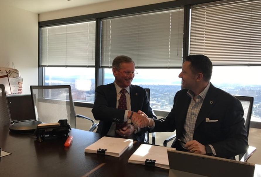 Jeff Lyon and Robert Thornburgh, signing to merge Heger/Kidder Mathews