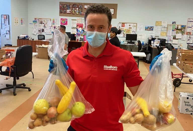 Riseboro CEO Scott Short handing out food at RiseBoro's food pantry in Brooklyn. 